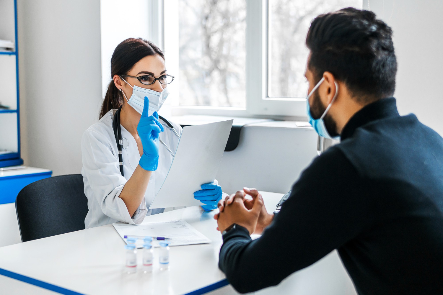 female-doctor-consults-her-patient-holds-documents-her-hands